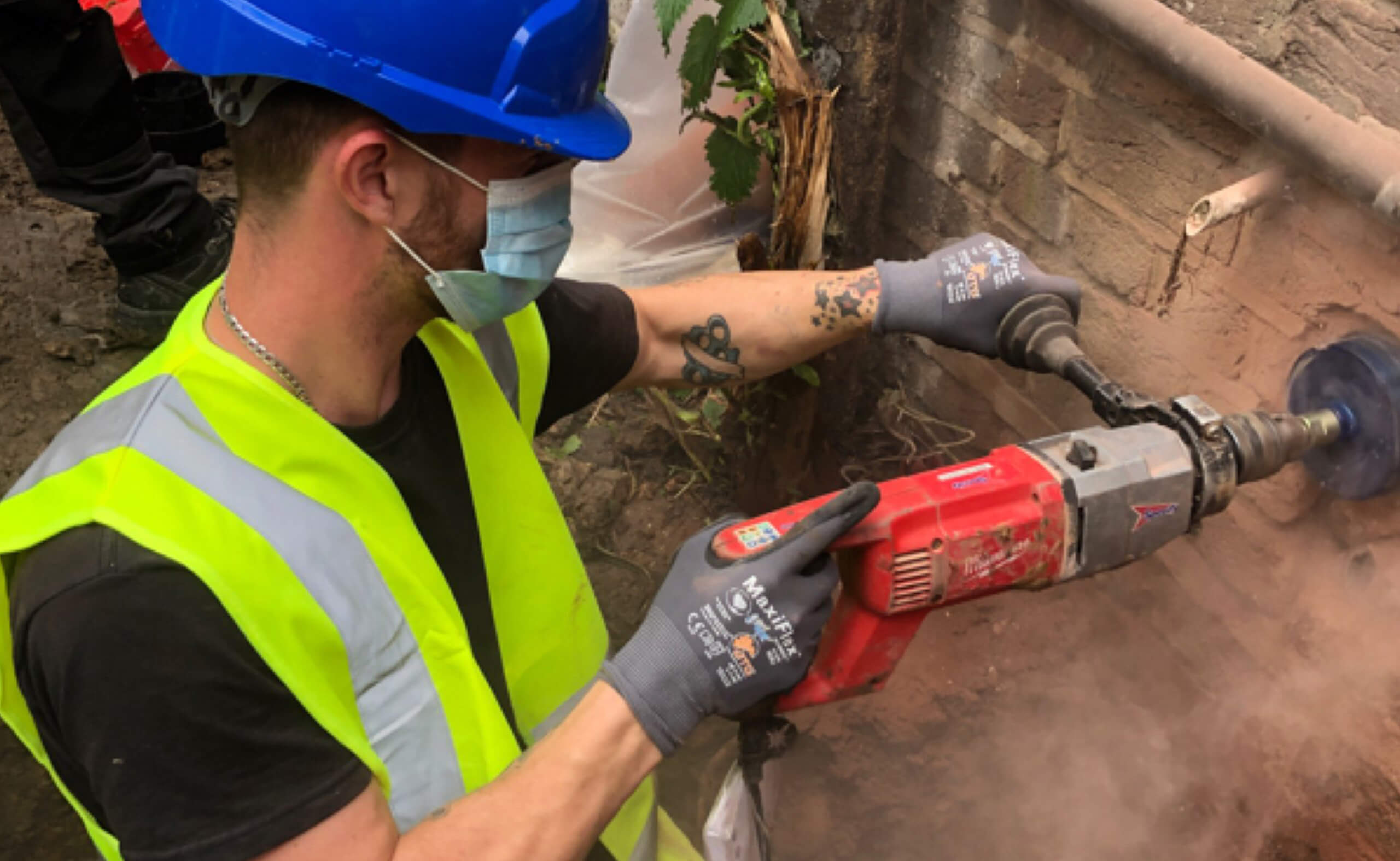 Aquevo engineer drilling through brickwork