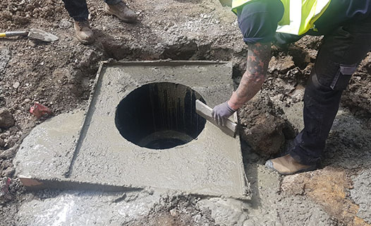Aquevo engineer lifting an inspection chamber